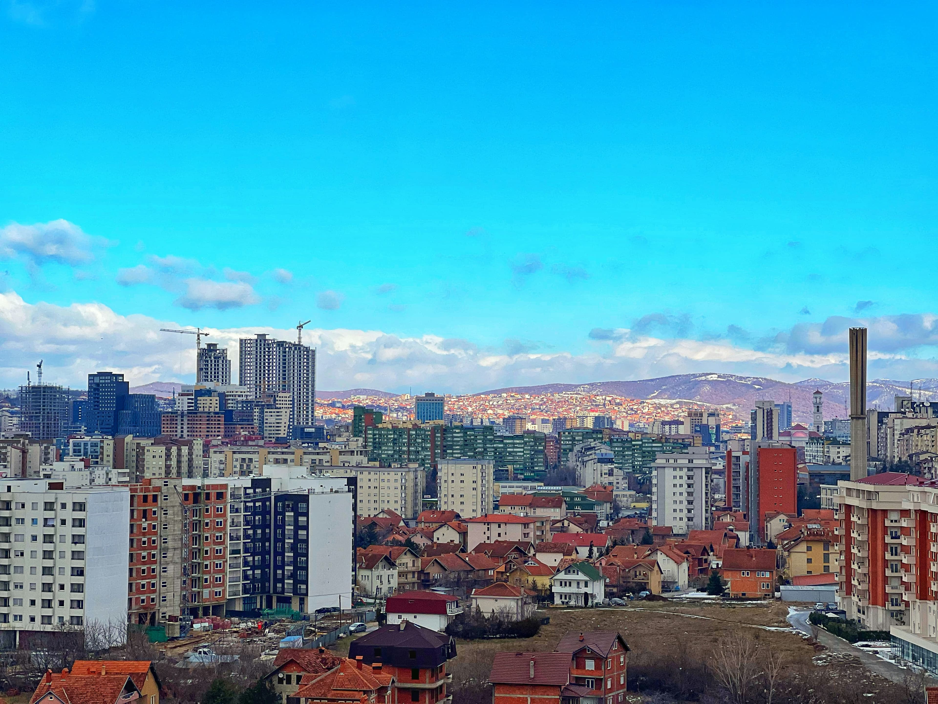 The Prishtinë skyline under a blue sky